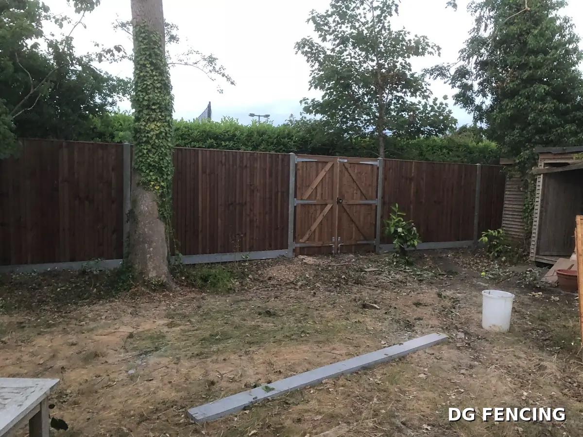 Dark stained closeboard fencing with matching double gates